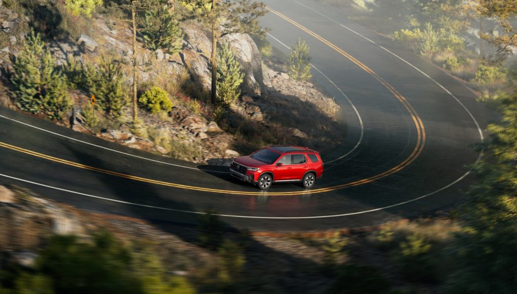 Honda Pilot SUV on a winding road Honda Pilot SUV on a winding road