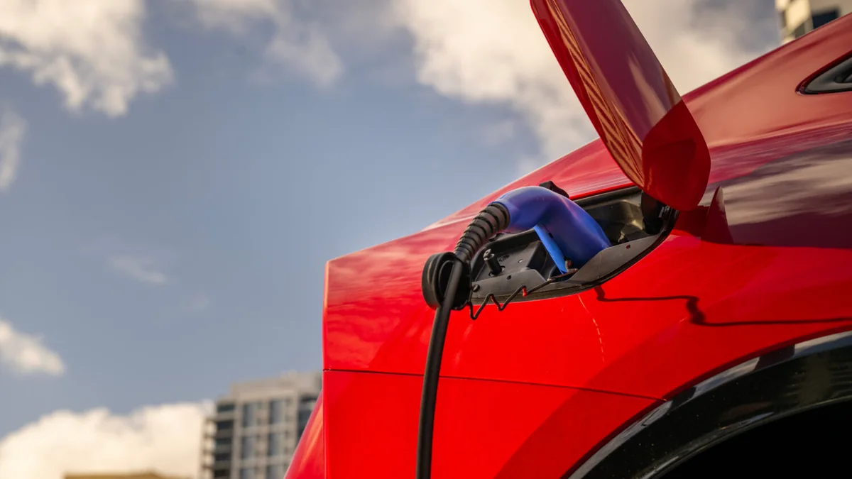 2027 Toyota Prius Plug-in Hybrid in red front three-quarter view