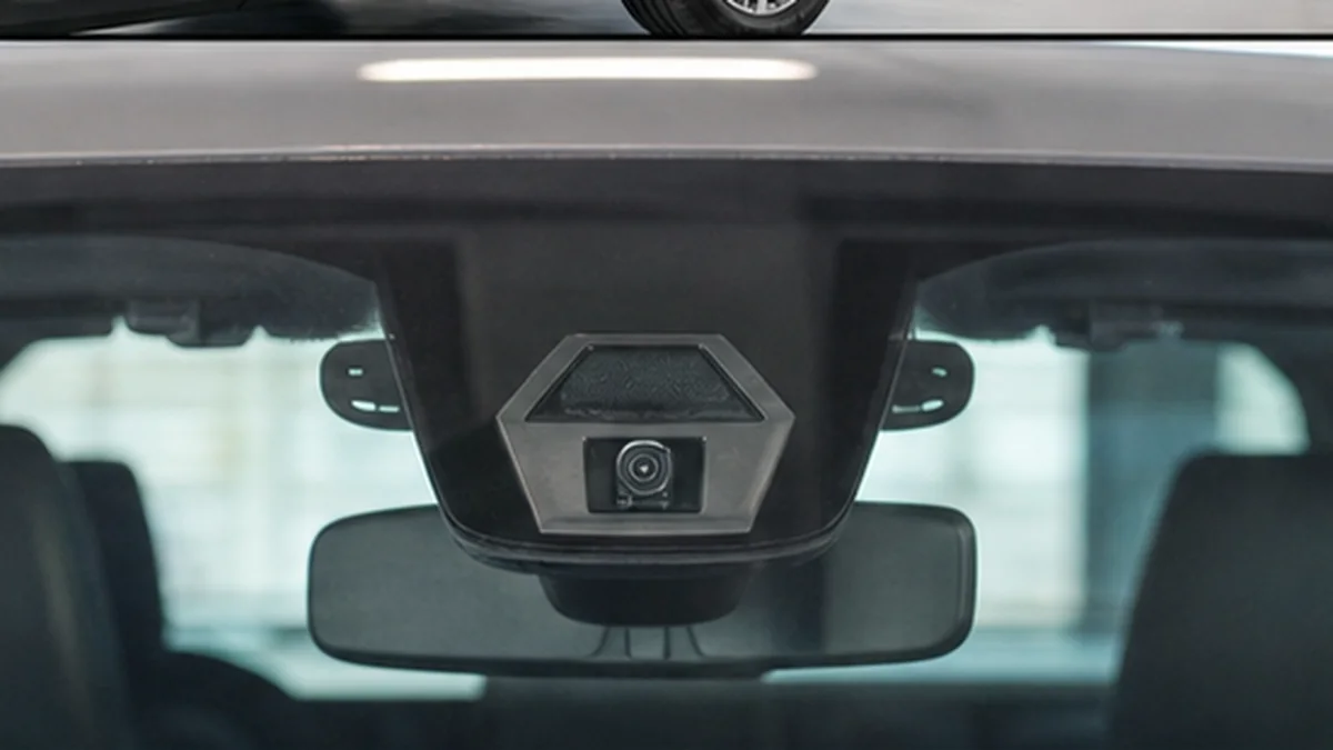 Forward-facing ADAS camera mounted behind a modern car windshield