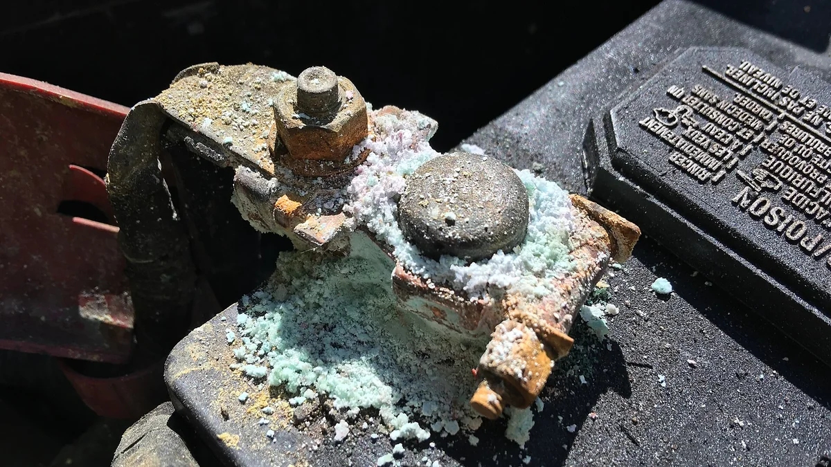 Corroded automotive battery terminals requiring inspection and cleaning