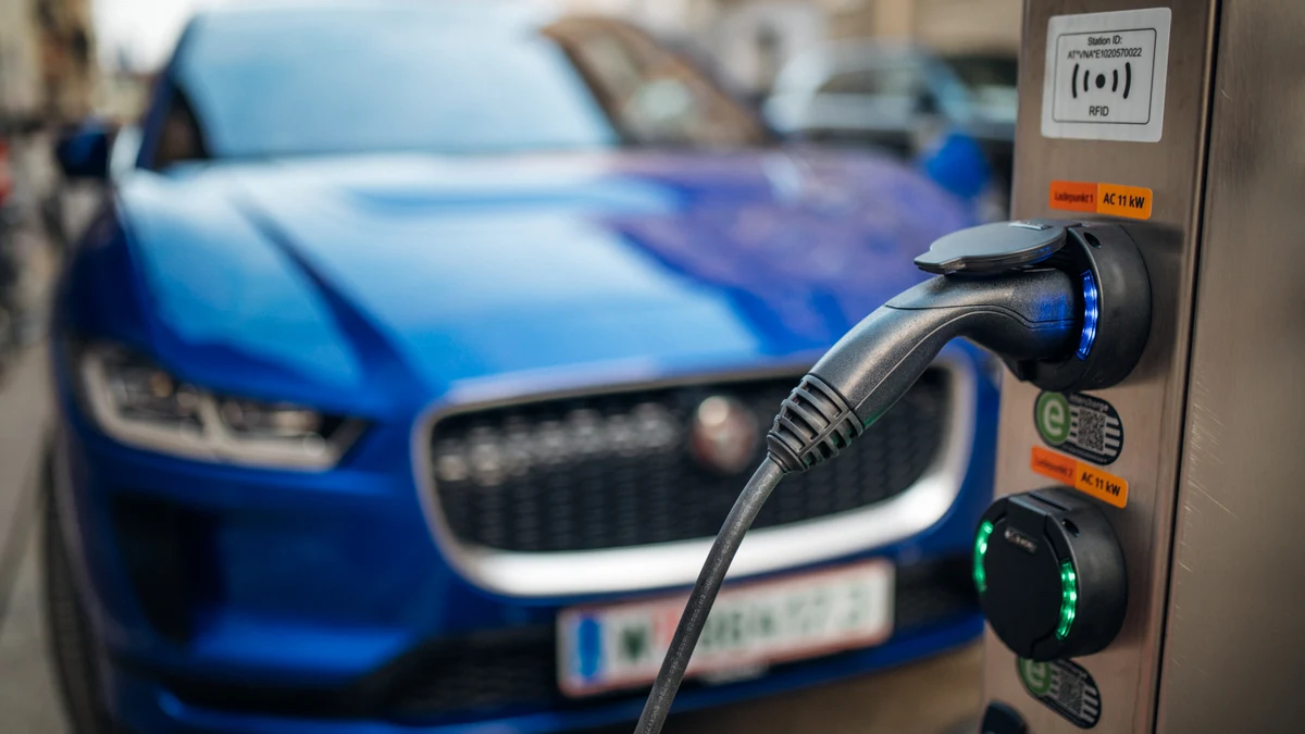 Electric car beside a public charging connector