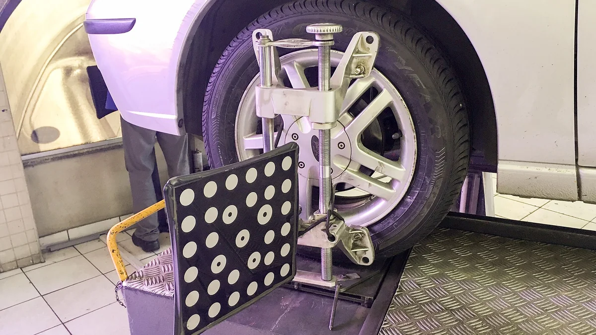 Wheel alignment target and sensor on a vehicle in a workshop