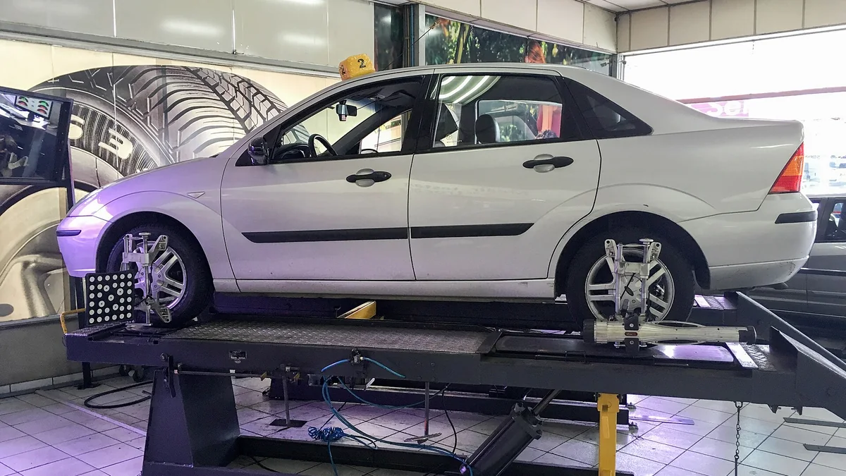 Ford Focus positioned on a four-wheel alignment rack